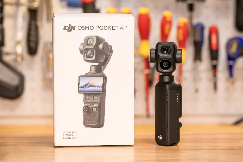 A picture of the DJI Osmo Pocket 4P and its box on a workbench in front of tools in soft focus in the background.