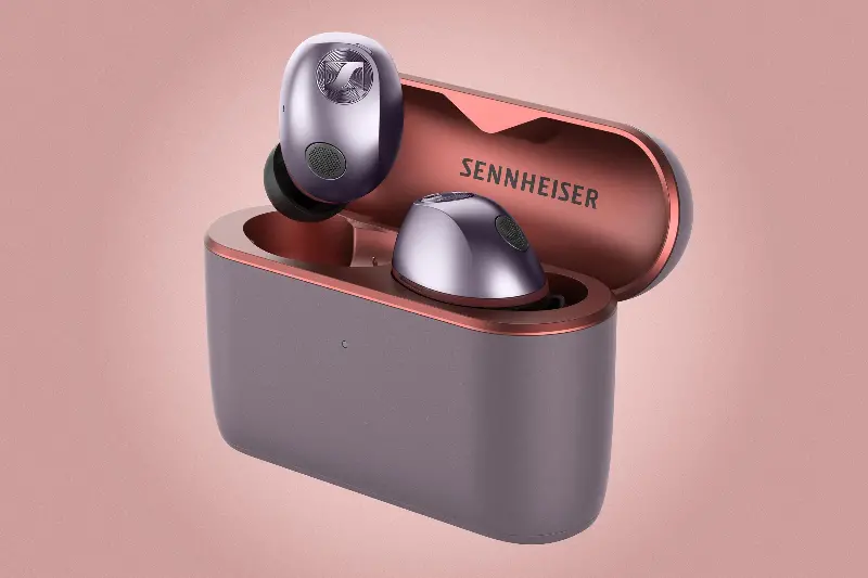 The Sennheiser Momentum True Wireless 5 earbuds with the lid open and one earbud popping out.