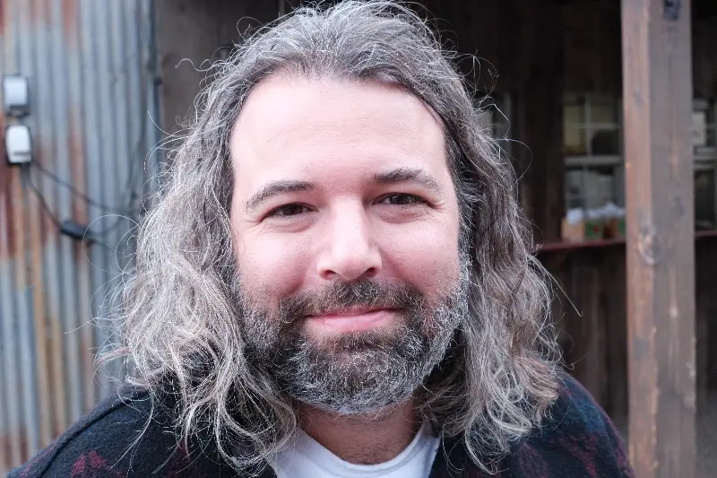 A portrait of Joseph Fink with his gorgeous flowing gray locks and top notch beard.