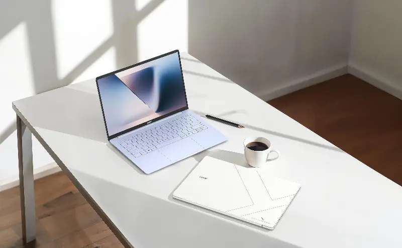 A pair of Acer Swift Blade 14 laptops on a desk with a cup of coffee.