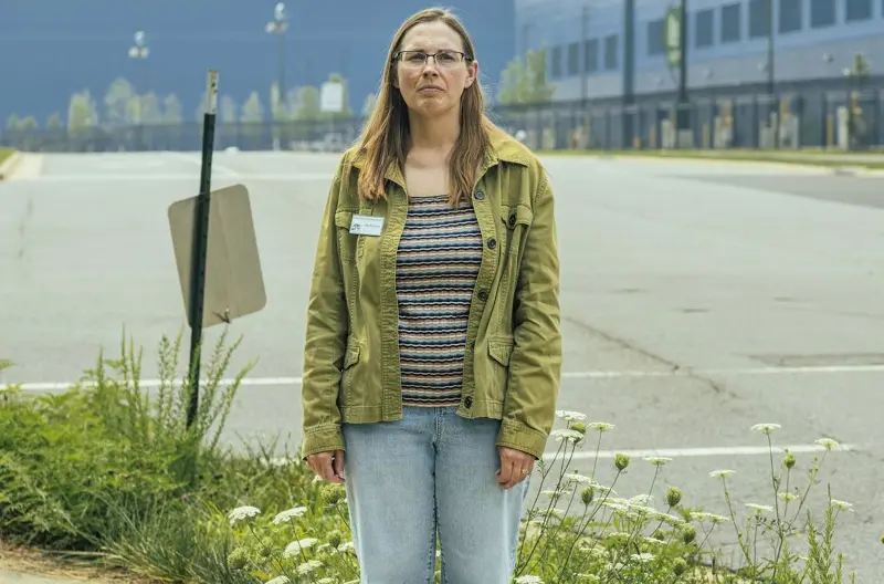 Piedmont Environmental Council land use director Julie Bolthouse stands in front of the blue Vantage VA2 data center in Ashburn, Virginia.
