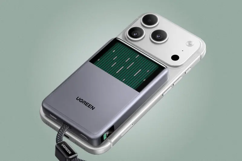 The Ugreen MagFlow Pro Magnetic Power Bank attached to the back of a smartphone with its liquid cooling window visible.