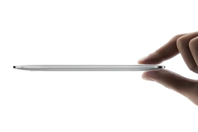 A person holds the Lexar Muse SSD drive between two fingers.