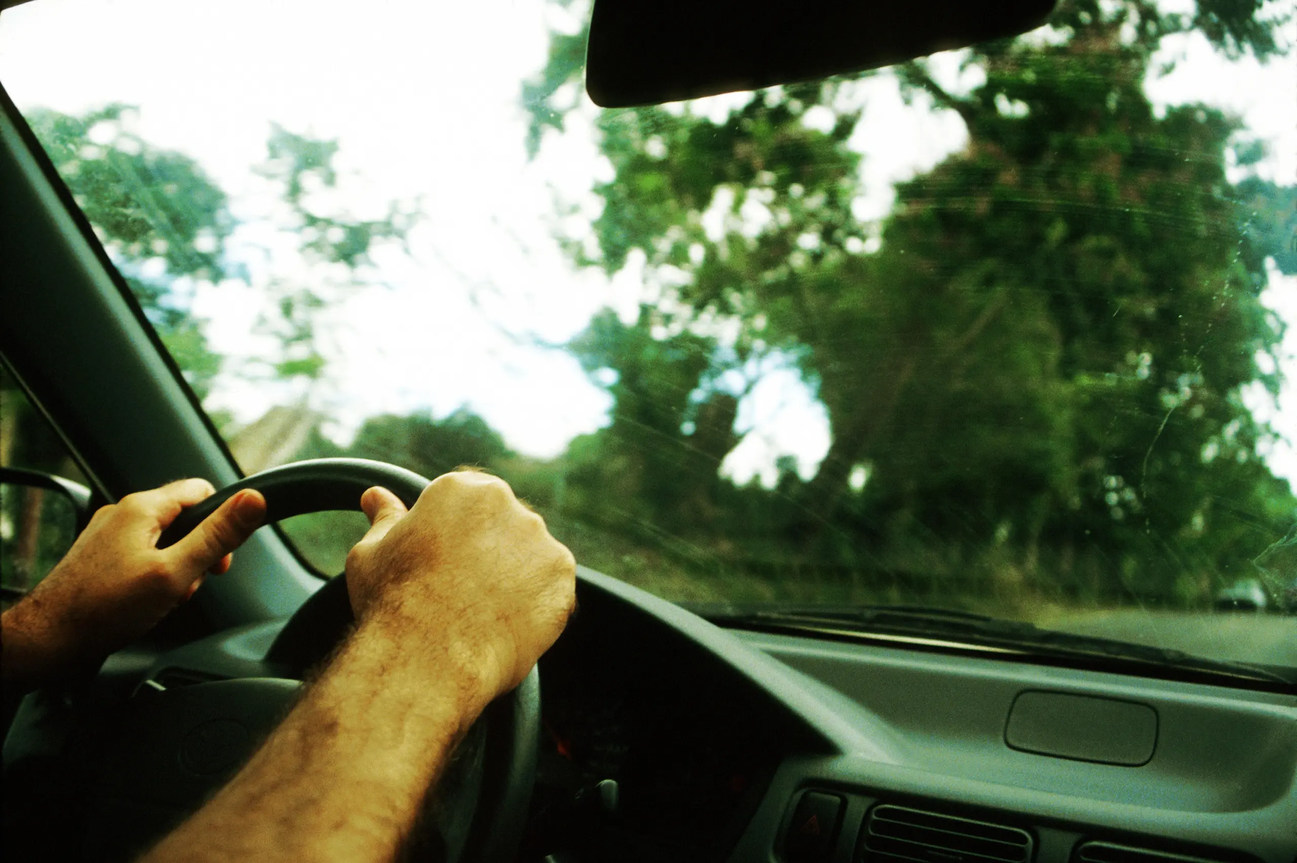 Hands of man on steering wheel