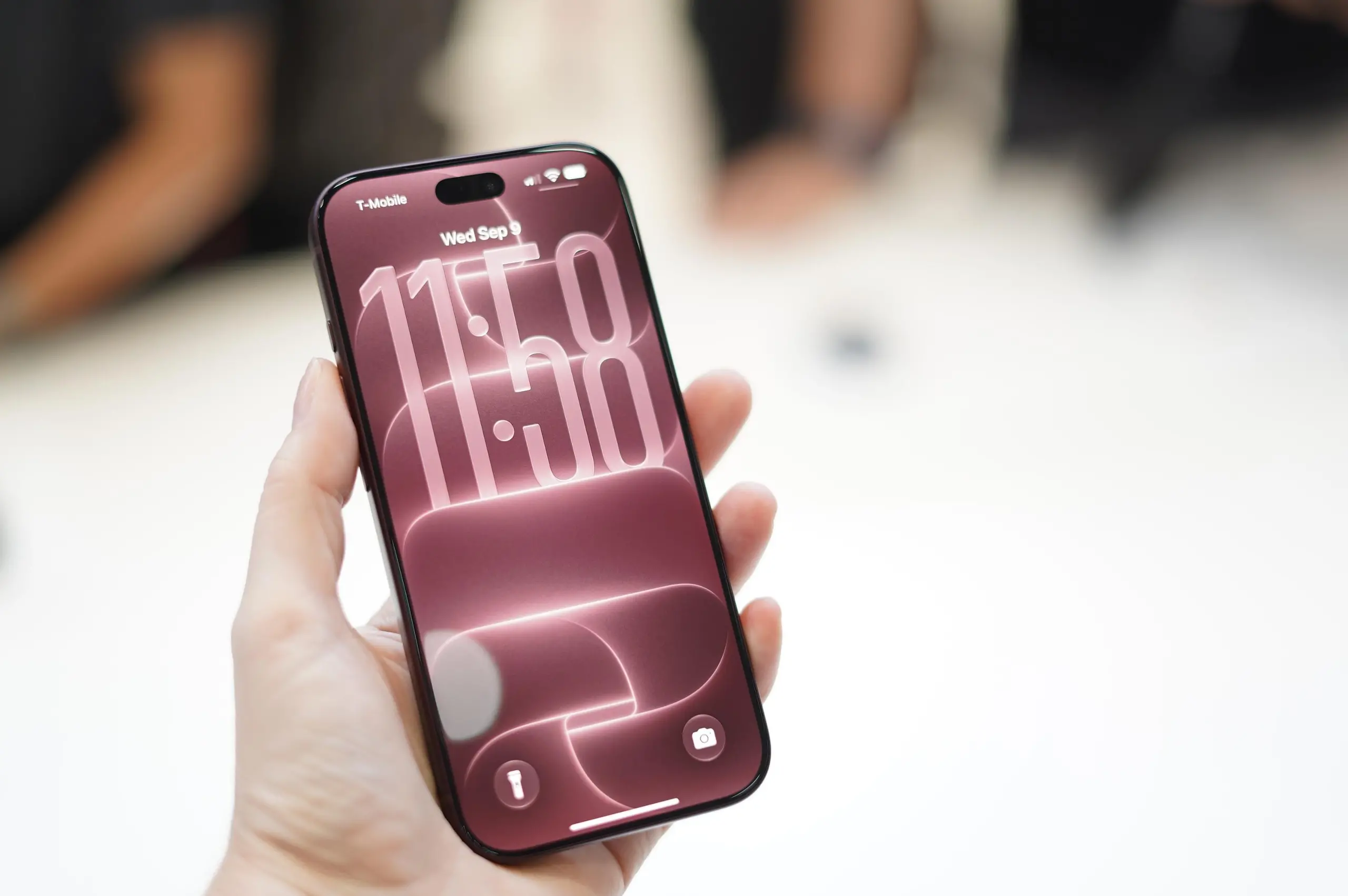 A person holding an iPhone 18 Pro phone.