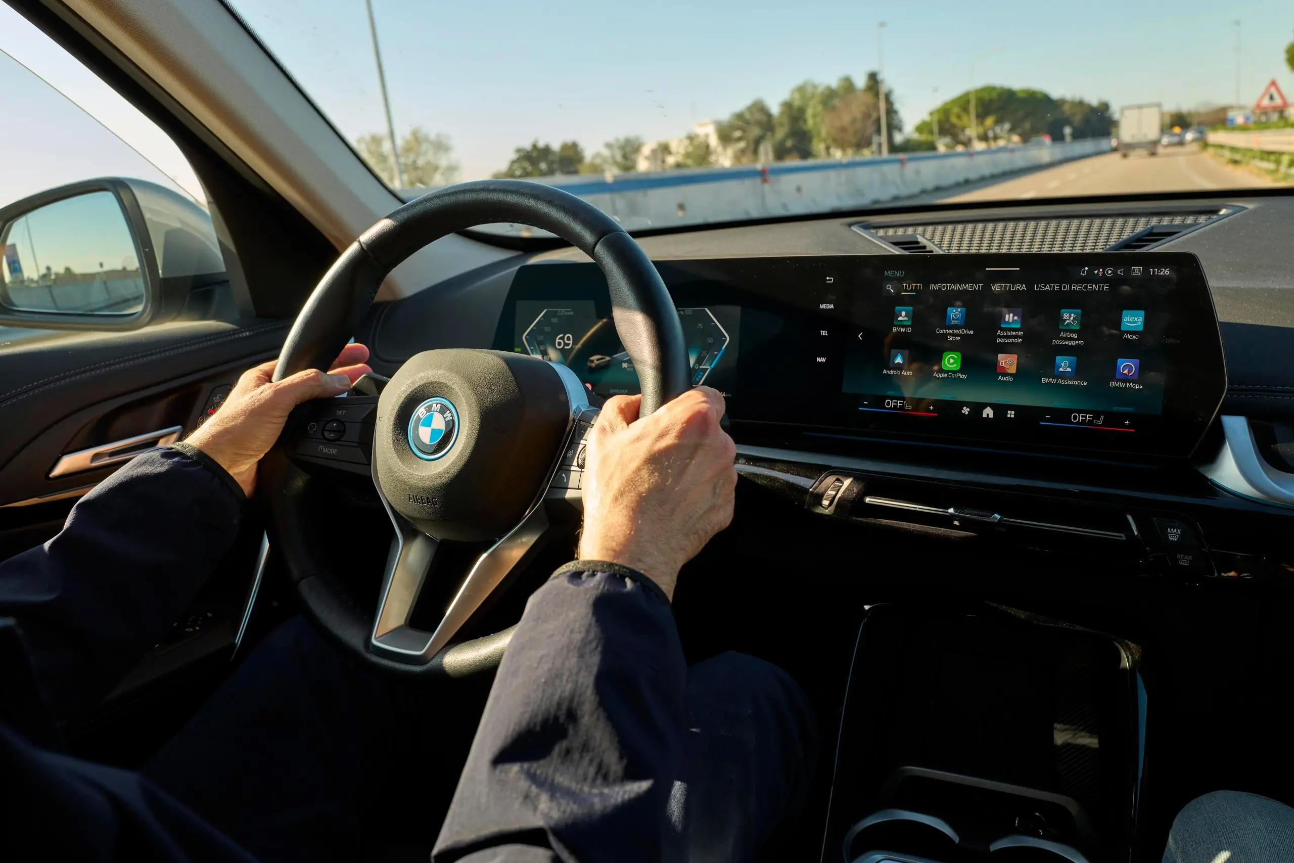 hands on steering wheel in a BMW