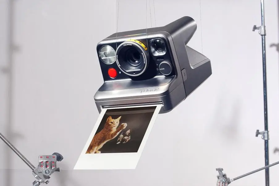 The Polaroid Mod camera ejecting an instant photo of a cat.
