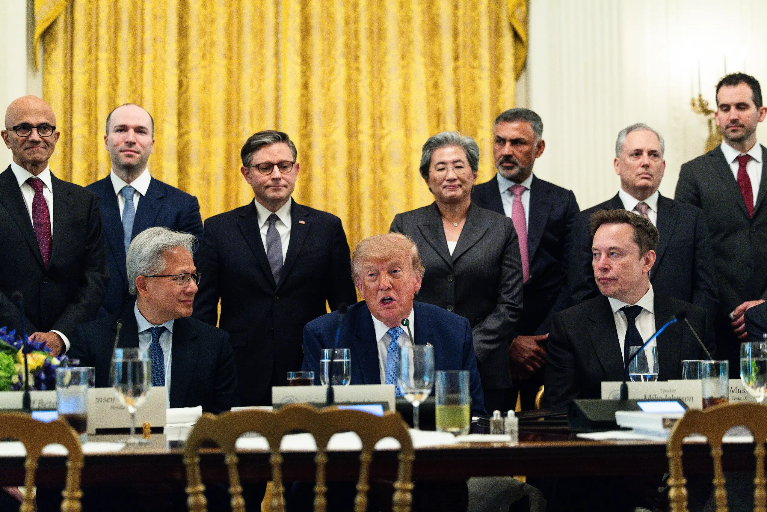 Satya Nadella, chief executive officer of Microsoft Corp., from left, Greg Brockman, president and co-founder of OpenAI Inc., Jensen Huang, chief executive officer of Nvidia Corp., US House Speaker Mike Johnson, a Republican from Louisiana, US President Donald Trump, Lisa Su, chair and chief executive officer of Advanced Micro Devices Inc. (AMD), Nikesh Arora, chief executive officer at Palo Alto Networks Inc., and Elon Musk, chief executive officer of Tesla Inc., during a meeting with tech executives on artificial intelligence in the East Room of the White House in Washington, DC, US, on Tuesday, Sept. 29, 2026. The gathering follows a surge in concern about AI potentially posing a threat to humans. 