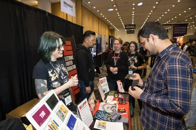 visiting an exhibit table at TechCrunch Disrupt 2024