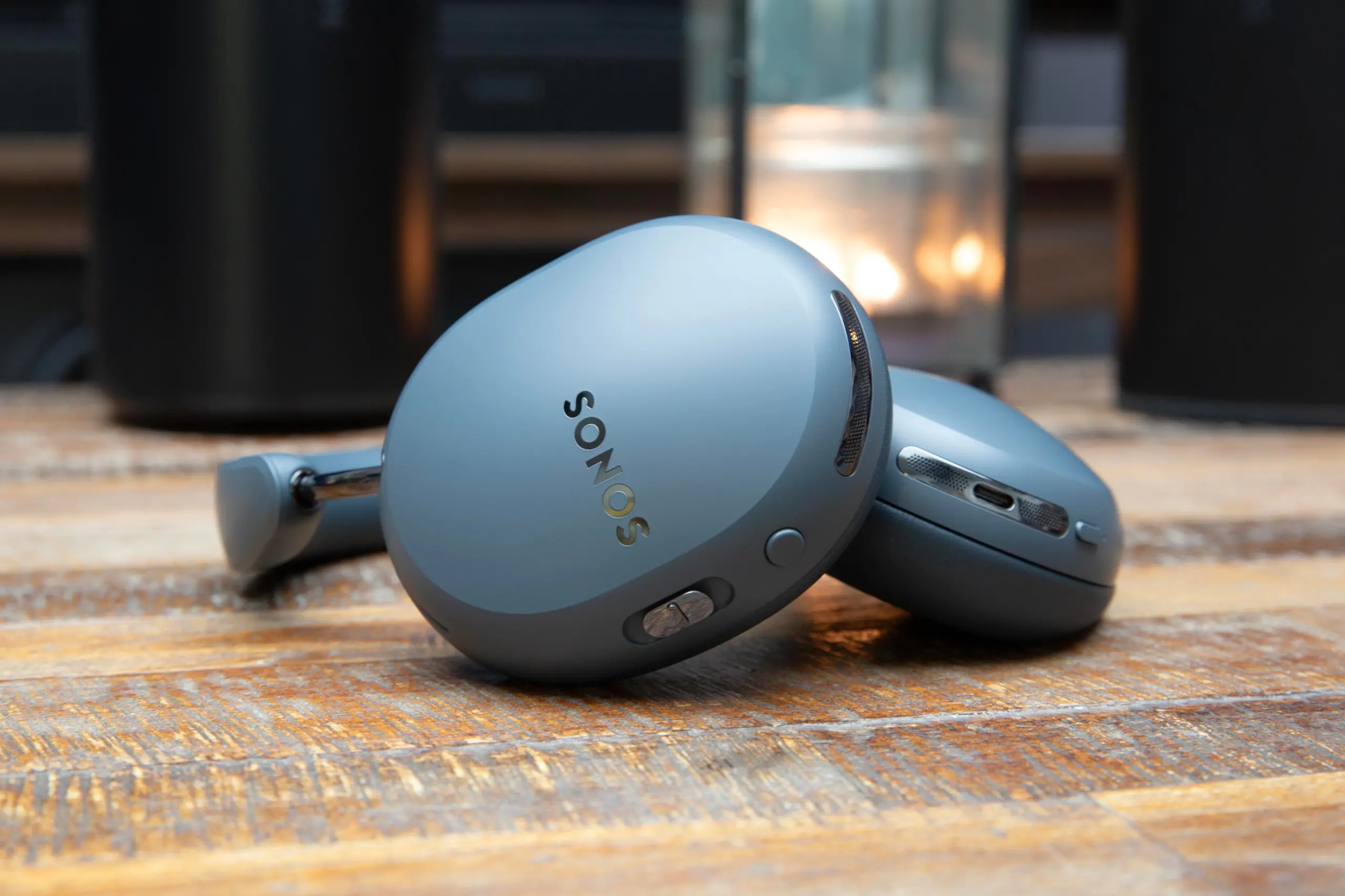 Sonos Ace Ultra headphones in Agave on a wooden tabletop.