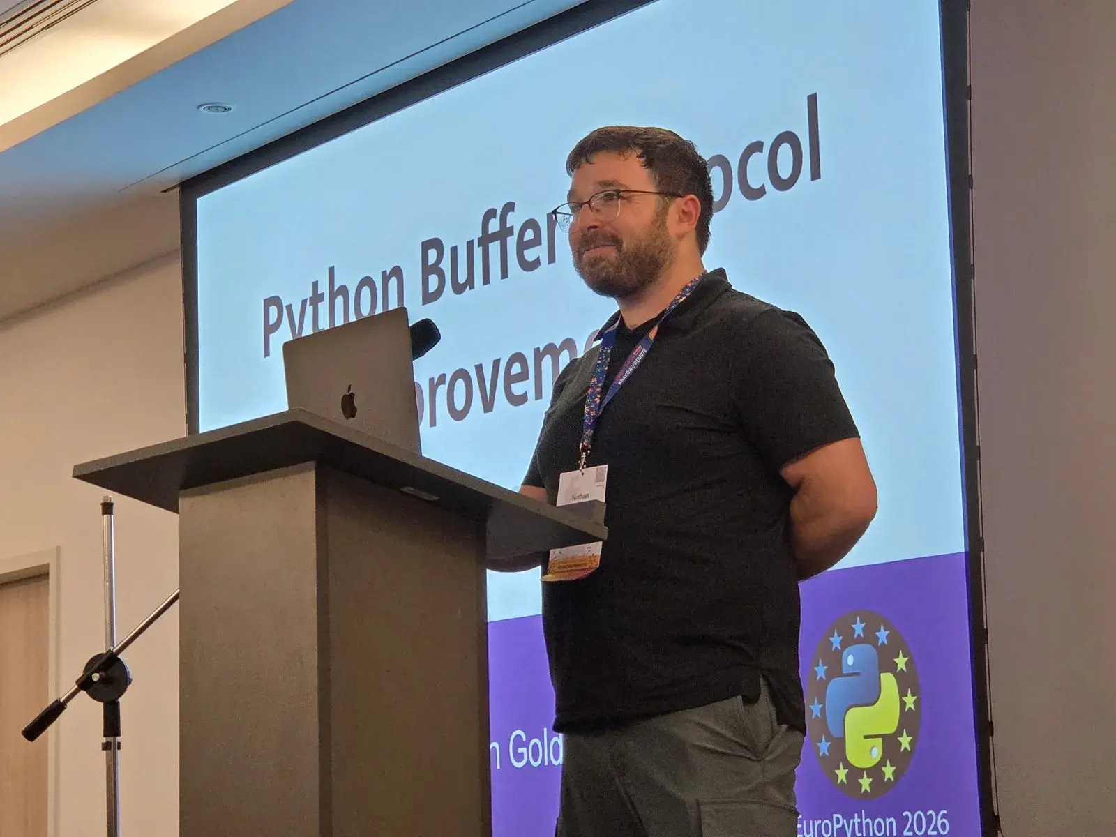 Nathan Goldbaum at the lectern, in front of his title slide “Python Buffer Protocol Improvements”