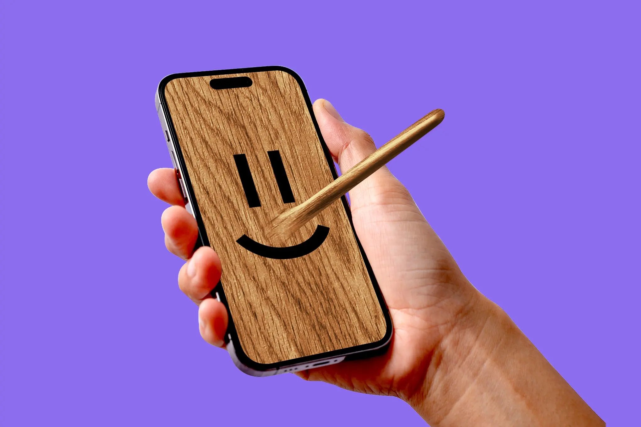 Person’s hand holding a phone with a wooden face and Pinocchio nose.