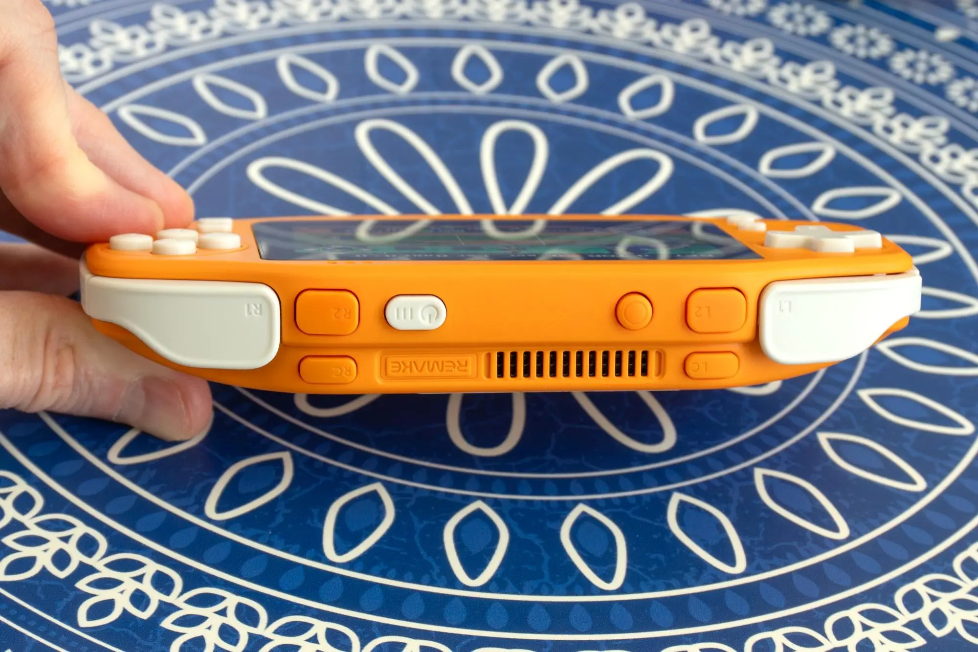 A photo showing all the buttons on the top edge of the Ayaneo Konkr Pocket Advance.