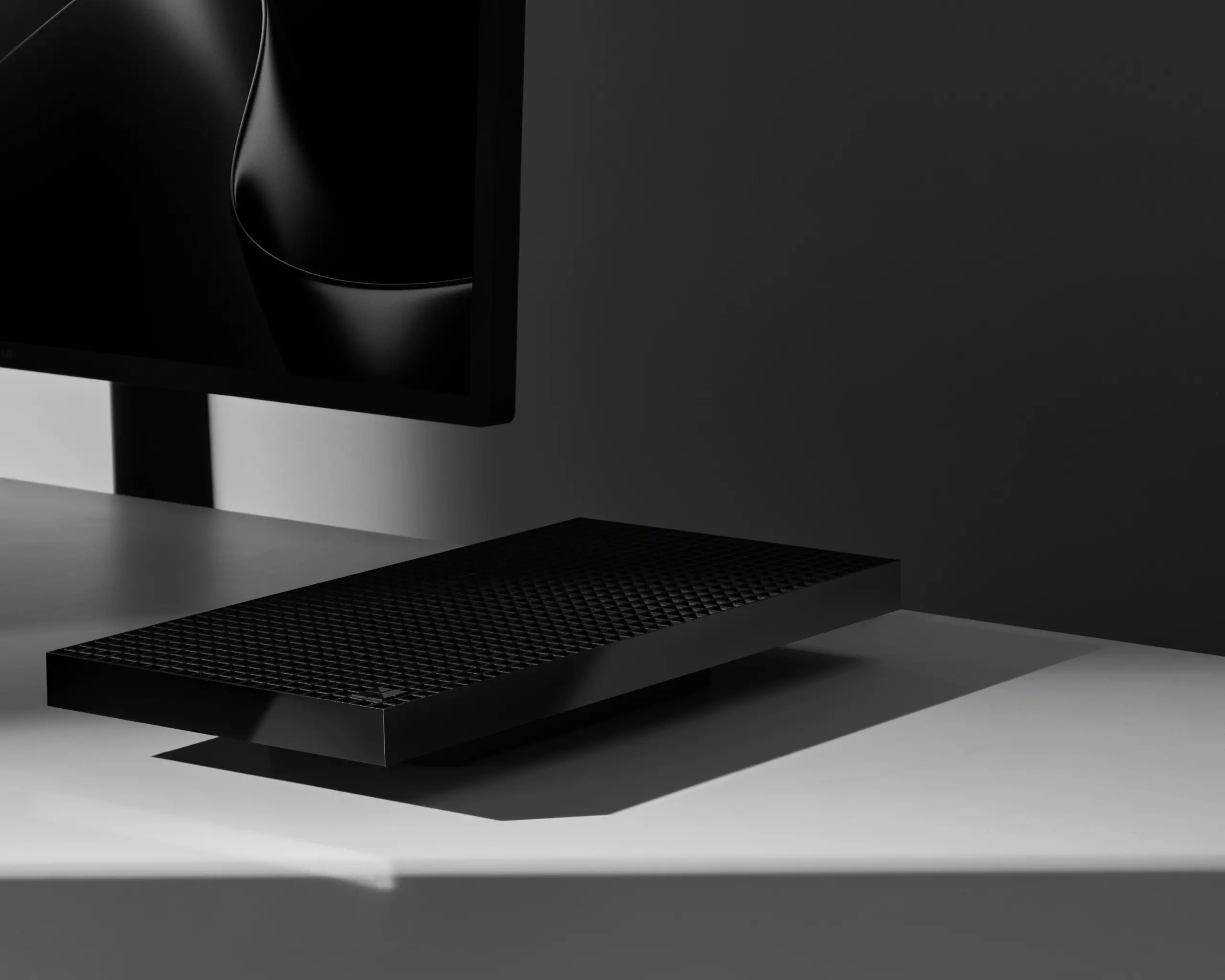 A Microsoft Surface RTX Spark Dev Box on a desk by a monitor