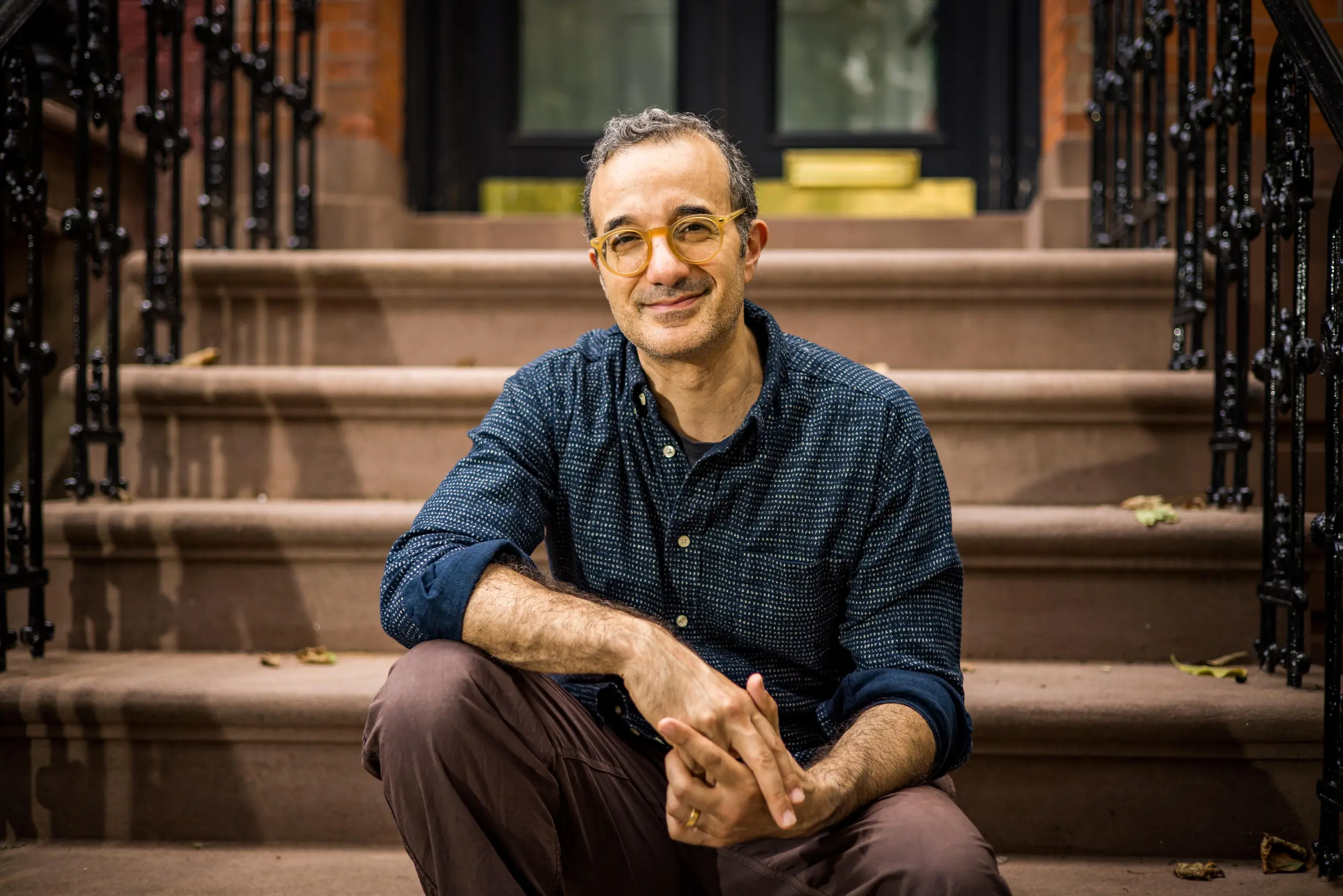 Jad Abumrad on a stoop in Brooklyn.