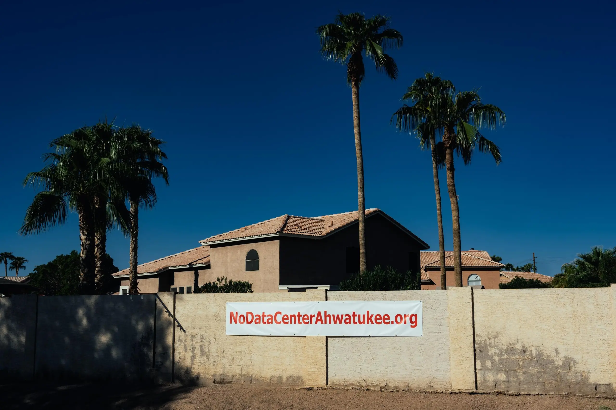 Sign reads "NoDataCenterAhwatukee.org" on a wall in an Arizona neighborhood.