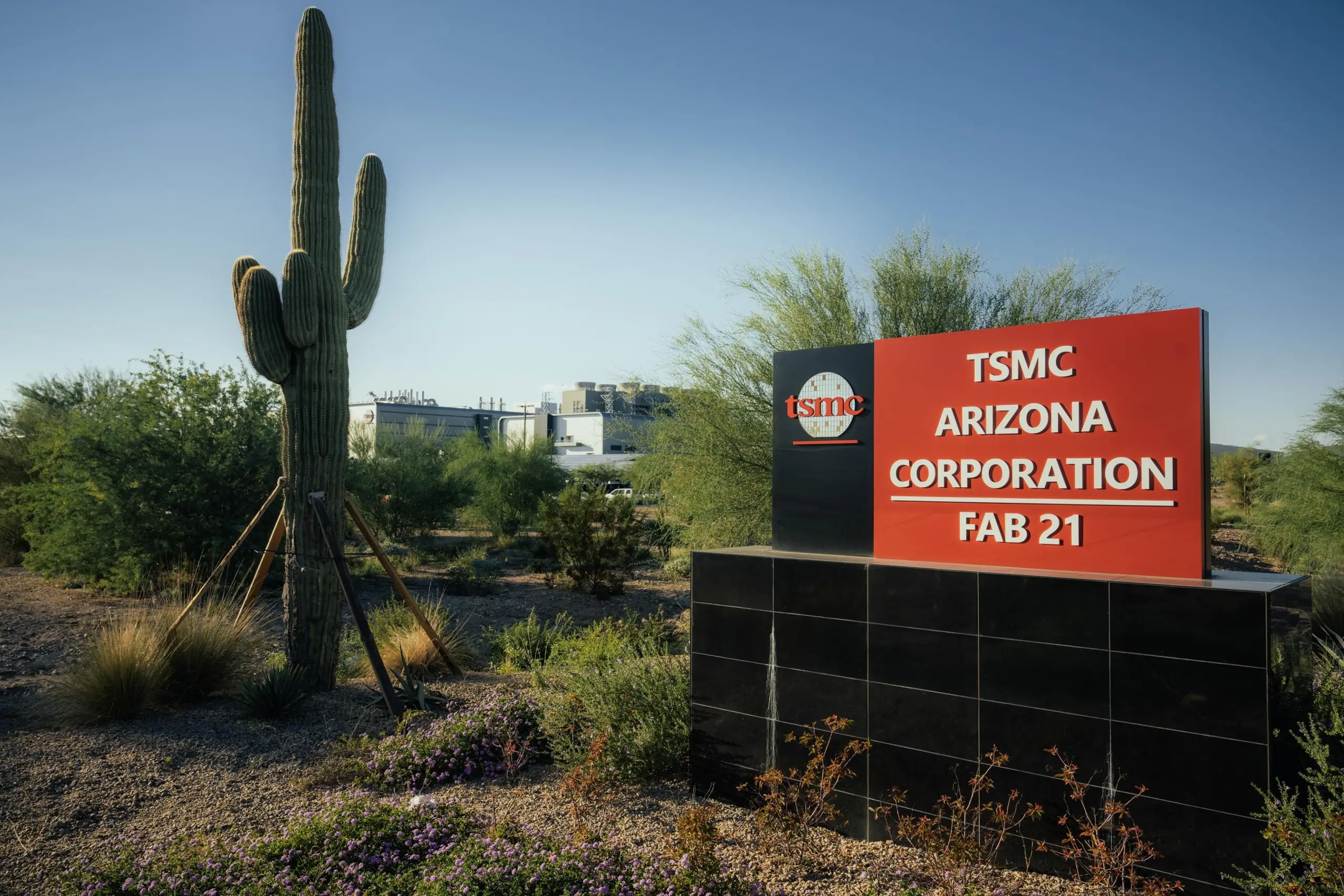 Sign outside the TSMC fab in Arizona next to a cactus.